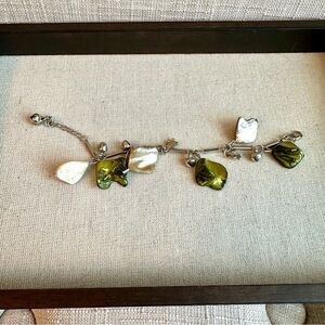 Silver colour metal bracelet with green and white mother of pearl charms